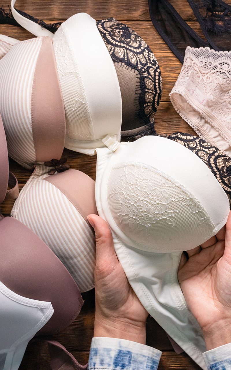 Woman is choosing a new underwear in a lingerie shop.